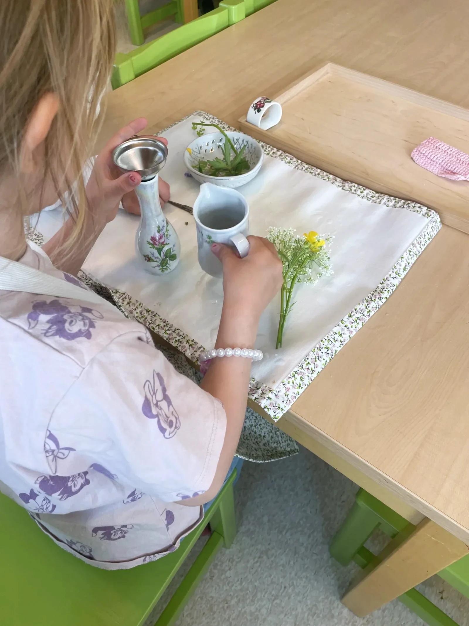 Barn ordnar blomar i vase
